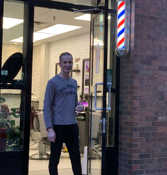 Ralph standing in the doorway of Ralph's Barber Shop
